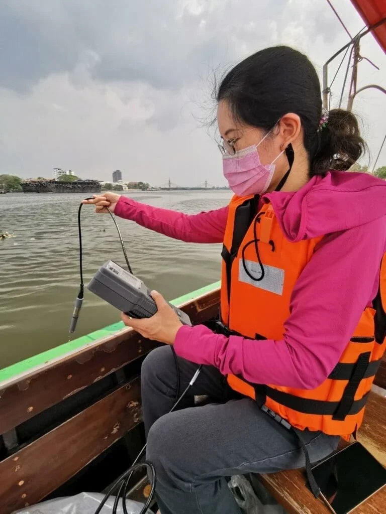 Dr. Kwanrawee Joy Sirikanchana collecting water samples from the Chao Phraya River (Photo Courtesy of Dr. Sirikanchana)